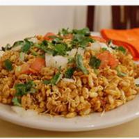 Bombai Bhel · Coldsalad of puffet rice, diced onions, tomatoes, cilantro & tamarind sauce.