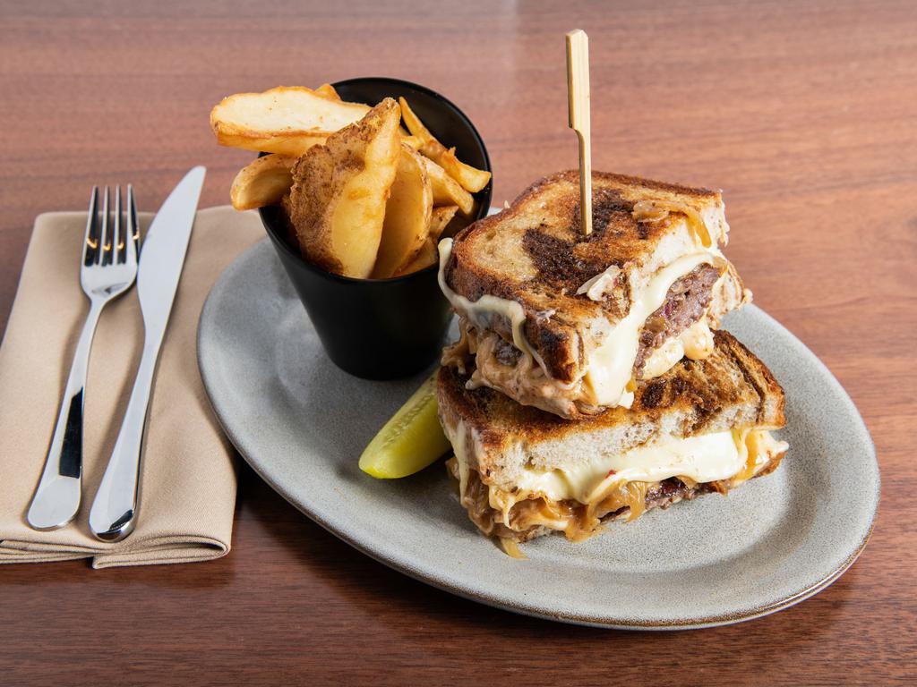 Patty Melt Burger · Double smashed house-ground prime chuck patties, swiss cheese, caramelized onions, russian dressing, thick cut marble rye bread, served with skin-on fries