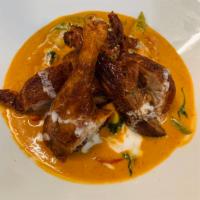 SP2. Crispy Duck Curry · Red curry with crispy roasted duck, pineapple, bell pepper, tomato and basil leaves.