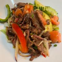 24. Beef Salad · Grilled sliced beef, onion, tomato, cucumber, bell peppers, mint and cilantro tossed in mild...