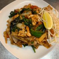 52. Pad Kee Mow Noodle · Stir-fried wide rice noodle with egg, onion, tomato, bell pepper, bamboo shoots and basil in...