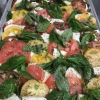 Caprese Salad · Fresh mozzarella, baby tomato, basil and extra virgin olive oil.