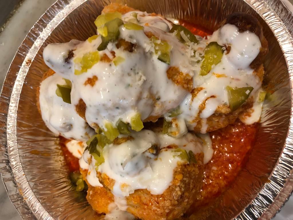 Buffalo Knots 5pc · Garlic Knots Tossed in Buffalo Sauce Topped w Ranch and Parmesan Cheese ( 5 Knots )
