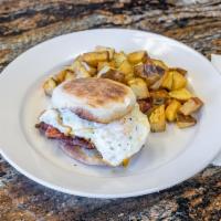 Ultimate Breakfast Sandwich · Toated English muffin loaded with crispy bacon, juicy ham slice, egg any style and cheddar c...