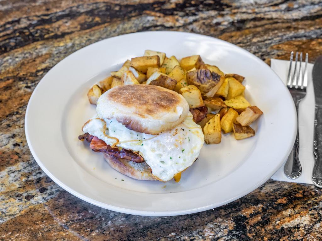 Ultimate Breakfast Burger Special · 1/2 lb. char-broiled juicy USDA hamburger patty topped with 2 slices of bacon, egg any style, melted cheddar cheese on a brioche bun. Served with tater tots or country potatoes.