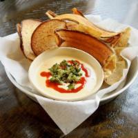 Queso Dip · Queso dip topped with poblanos, caramelized onions, hot sauce 