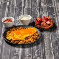 Mexican Skillet · Scrambled eggs over crisp hashbrowns, jalapenos, onions, cheddar cheese and chorizo sausage,...