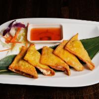 5 Pieces Crab Rangoon · Stuffed with kani, Philly cheese, minced carrot, onion and pineapple, served with duck sauce.