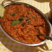 Baingan Bharat · Eggplant grilled over charcoal, mashed, and cooked with fresh tomatoes, onions, garlic, ging...