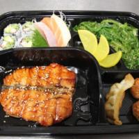 Salmon Bento Box · A combination of sashimi, salmon, California maki, seaweed salad, gyoza and shumai. Served w...