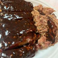 *1/2 Slab W/ Pulled Pork · 1/2 Slab of Pork Ribs & 4 oz of Pulled Pork served with your choice of sauce and 1 side.