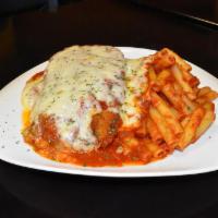 Eggplant Parmigiana · Hand-cut peeled eggplant in seasoned bread crumbs, fried, then baked in our house tomato sau...