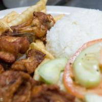 Chicharrones de Pollo · Fried chicken chunks served with french fries, rice and beans.