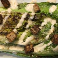 Grilled Caesar Salad · Wedge of Grilled Romaine, Parmesan, Croutons, Lemon, Caesar Dressing (Dressing contains anch...