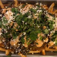 Mexican Street Taco Poutine · Shoestring French Fries, Marinated Flank Steak, House-Made Tomatilla Verde  Salsa, Peppers, ...