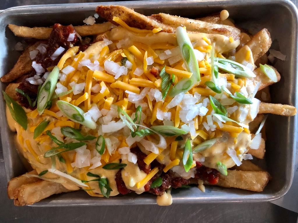 Chili Cheese Fries · French Fries, House-Made Three Meat Chili (Bacon, Beef, Pulled Pork), House Queso Sauce, Chedddar, White Onions, Green Onions