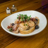 Grilled Shrimp Scampi · Grilled jumbo shrimp topped with lemon butter sauce, sundried tomatoes, artichokes and toppe...