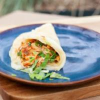 Chicken Tinga Quesataco · Our finger-licking signature dish, a unique mix of savory adobo marinated chicken breast ove...