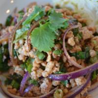 LARB · Minced meat salad flavored with fish sauce, lime juice, and roasted ground rice ad herbs. Se...