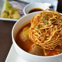 KHAO SOI · Northern style red curry with egg noodles, chicken drumsticks, and topped with crispy egg no...