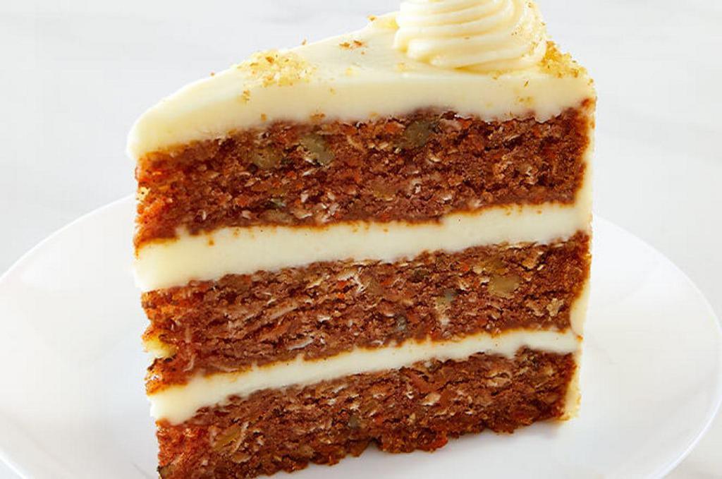 Colossal Carrot Cake · Giant slice of moist carrot cake with walnuts and cream cheese frosting.