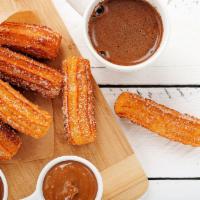 Churros  · With dulce de leche and chocolate.