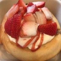 Strawberry Shortcake Cinnamon Roll · Cream cheese and strawberry frosting topped with fresh sliced strawberries and strawberry dr...