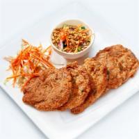 Fish Cake · Deep fried fish cake served with cucumber salad.