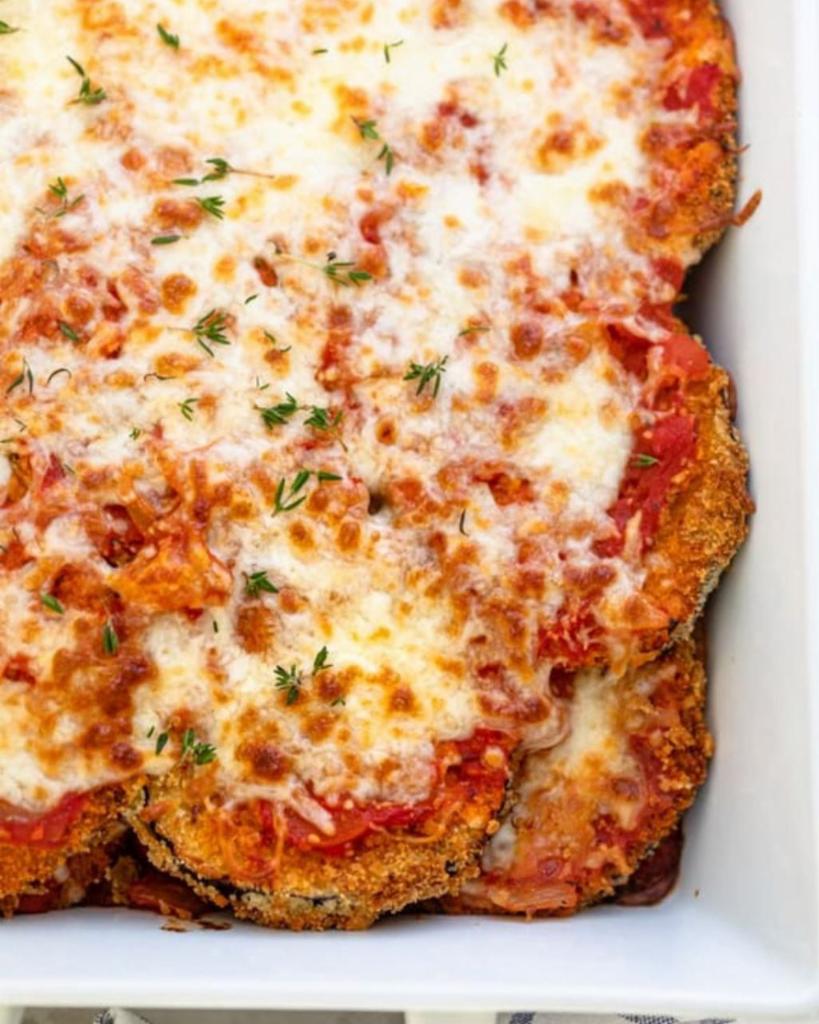 Eggplant Parmigiana · Breaded and fried to order. Eggplant topped with mozzarella cheese served with tomato or marinara sauce. Served with a side of ziti.