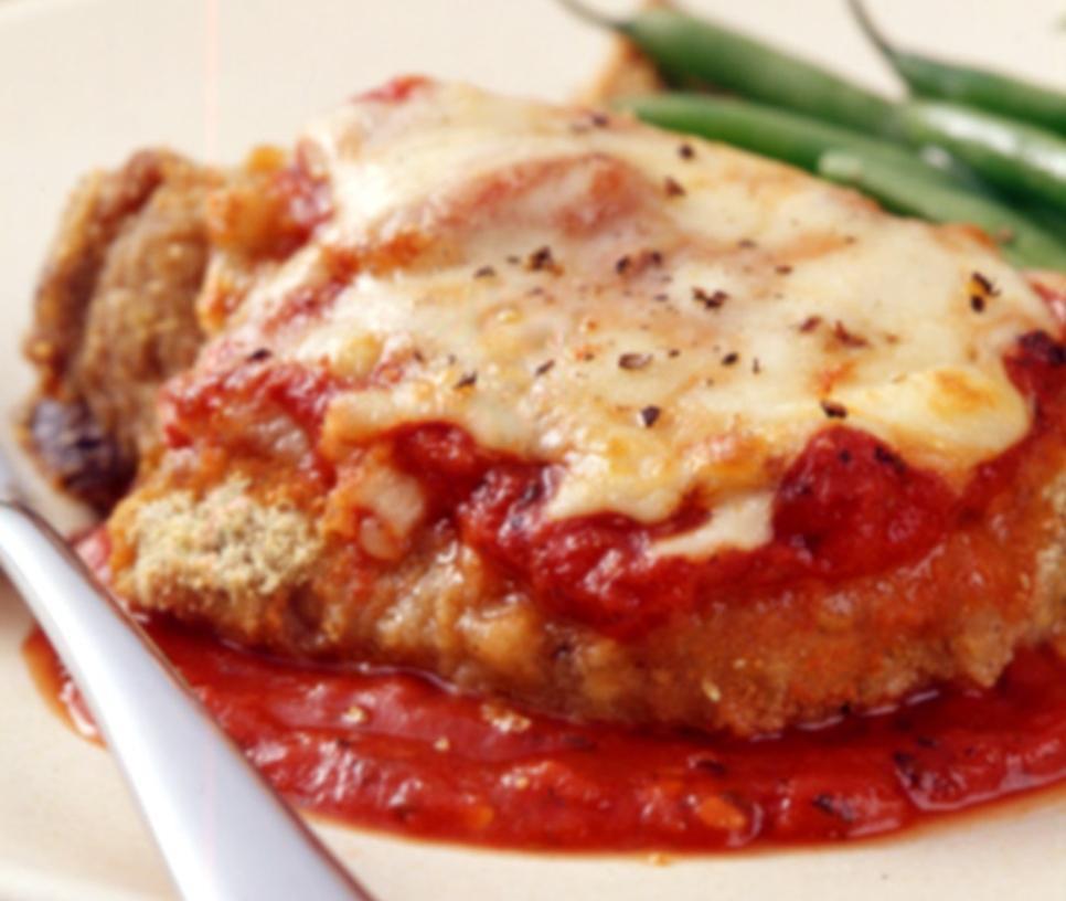 Veal Parmigiana · Italian style breaded veal cutlet baked in tomato sauce and topped with mozzarella cheese and served with a side of ziti.