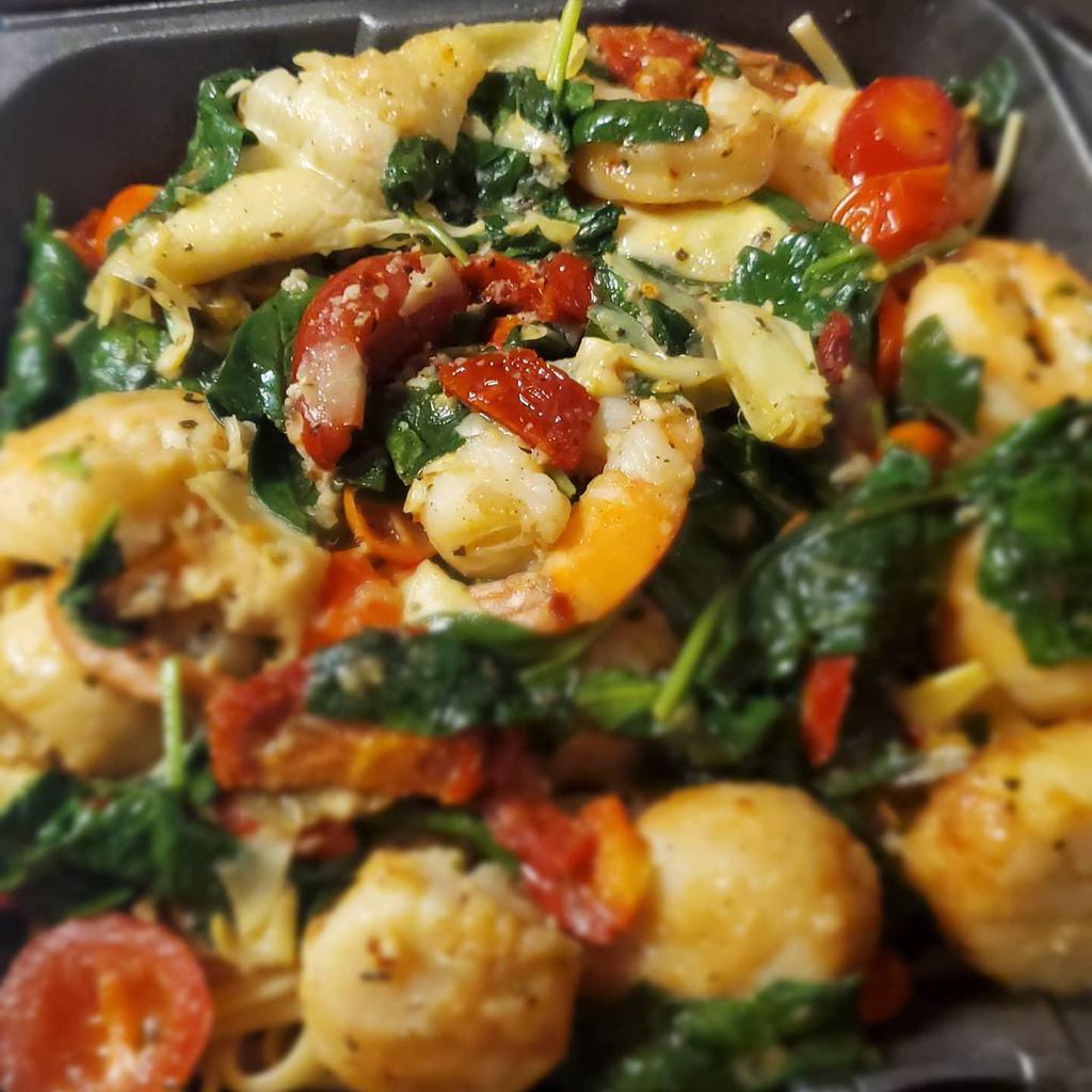 Shrimp & Scallops · Sautéed in a garlic wine sauce with artichokes, spinach,  sundried & fresh tomatoes over linguine 