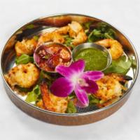 Tandoori Shrimp · Shrimp mildly marinated with garlic, cilantro and black pepper. Served with rice, masala sau...