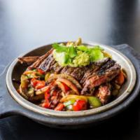Steak Fajitas · Served on pan-roasted red and green bell peppers, onions, tomatoes , rice, beans , guacamole...