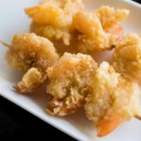 Popcorn Shrimp Sate · 2 skewers of breaded shrimp seasoned with butter sauce.