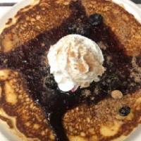 Wildberry Crumble Pancakes · Blueberries, Streusel, Our Homemade Berry Jam & Whipped Topping