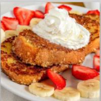 French Toast Crunch · French toast coated with a granola-coconut crunch, strawberries, bananas, and whipped cream.