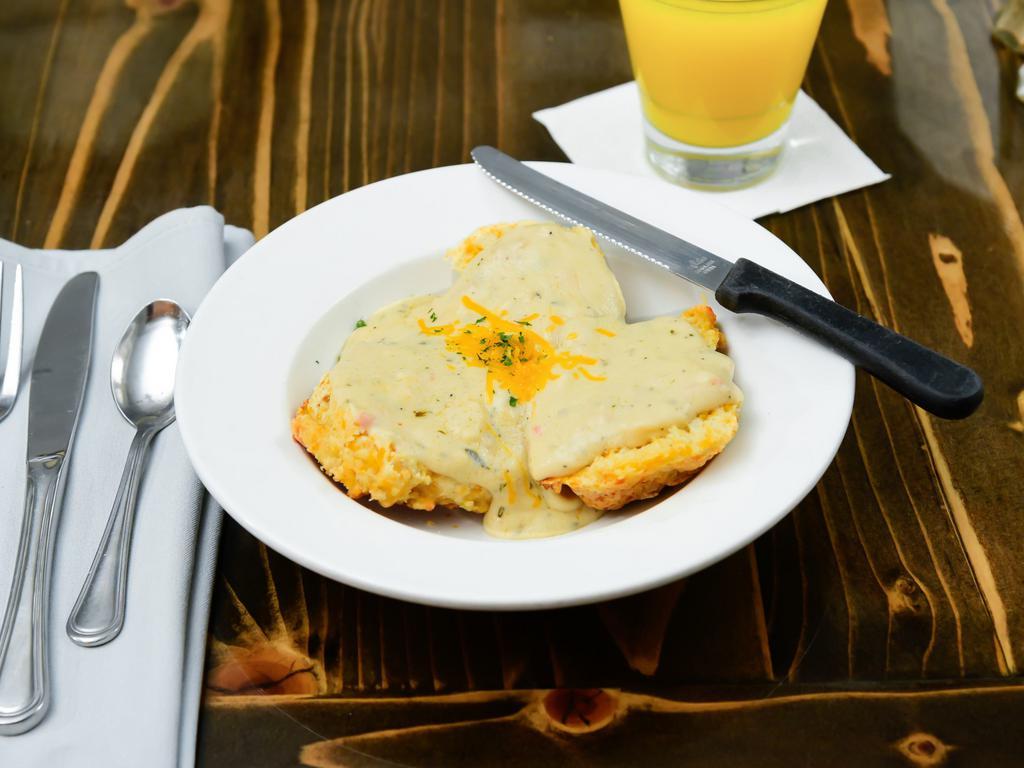 Biscuits and Gravy · Our housemade cheddar cheese buttermilk biscuits served with our housemade British herb gravy (vegetarian).