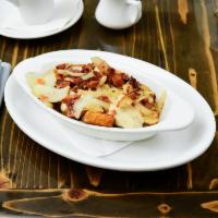 Hatter’s Way · Smothered in our British herb gravy, topped with sauteed onions and applewood smoked bacon.
