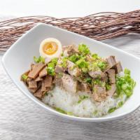 Pork Chashu Rice Bowl · Succulent pork pieces and 1/2 soft boiled egg served over rice with bamboo shoots, green oni...