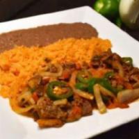 Bisteck a la Mexicana · Steak tips cooked with jalapeno peppers, tomatoes and onions. Served with rice and beans.