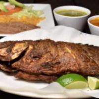 Mojarra Frita · Fried tilapia served with rice, beans, and salad.