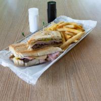 Sandwich Cubano · Sliced ham, marinated pork, Swiss cheese, pickles and mustard on toasted Cuban bread.
