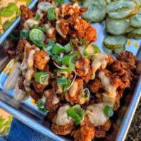 Popcorn Chicken · Fried popcorn chicken, topped with chipotle, side of pickles & Chipotle