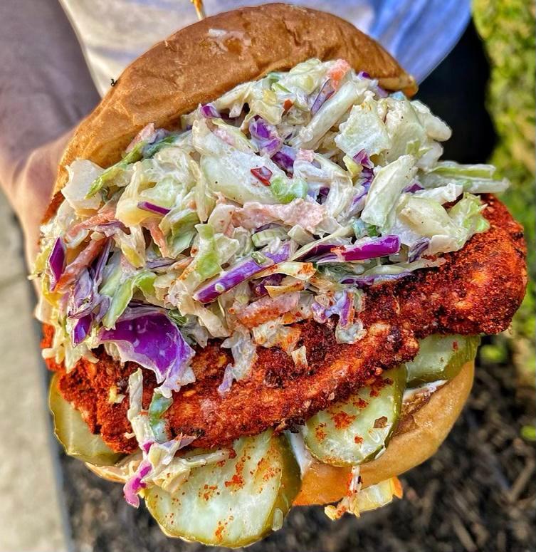 Spicy Grilled Chicken Sandwich · Spicy Marinated Grilled chicken breast, lettuce, tomatoes, grilled onions, pickles chipotle sauce on a Hawaiian bun with side of Garlic fries