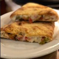 Chicken and Pepper Calzone · With grilled herb chicken, caramelized onions, oven roasted peppers and mozzarella.
