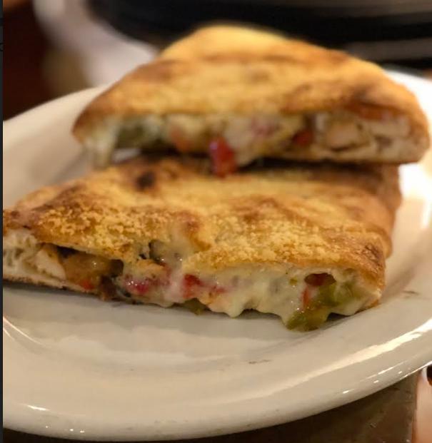 Chicken and Pepper Calzone · With grilled herb chicken, caramelized onions, oven roasted peppers and mozzarella.