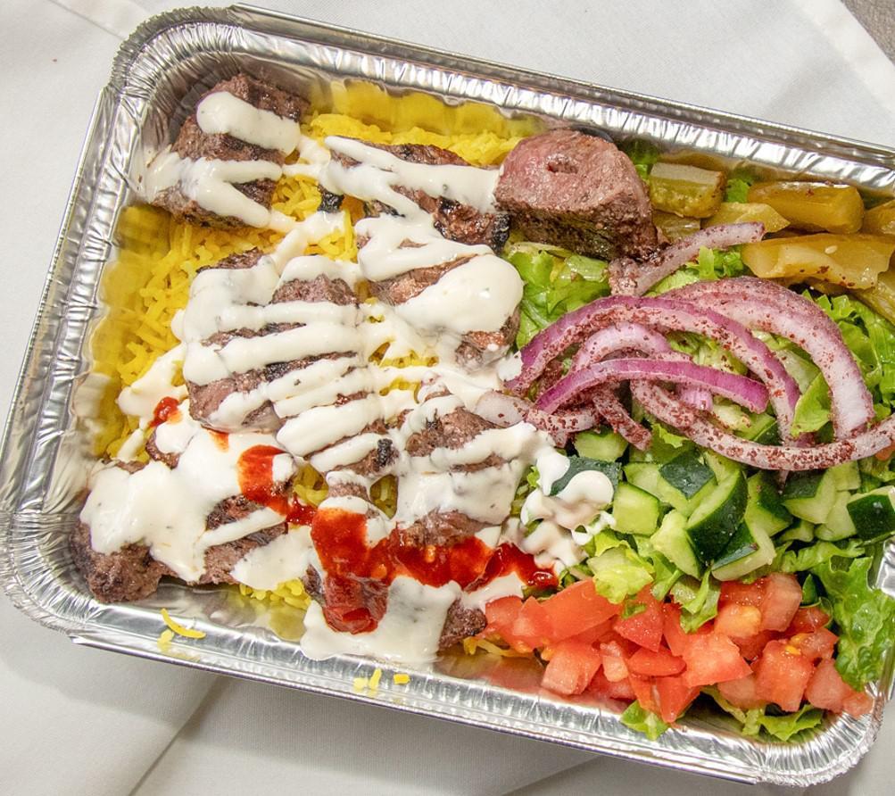 Beef Kebab over Rice · Marinated beef cubes grilled, over spiced basmati rice and a side salad. Served with our white sauce and hot sauce.