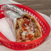 Chicken Shawarma Wrap · Marinated chicken breast, thin sliced wrapped in pita bread with tomato, onions, and our whi...
