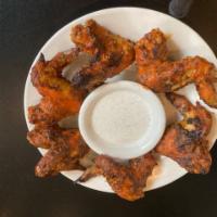 Sicilian Wings · Baked in hot sauce or BBQ sauce dip with ranch or blue cheese.