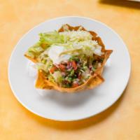 Taco Salad Fajitas · Crunchy flour tortilla bowl filled with grilled chicken or steak, melted cheese sauce, saute...